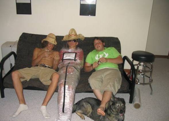 passed out drunk wrapped in saran wrap with sombrero