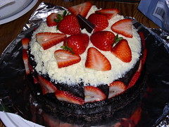 Dark chocolate cake with white chocolate ganche and strawberries